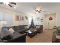 Bright living room with comfortable seating and a Christmas tree at 2135 N Heritage St, Buckeye, AZ 85396