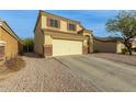 Two-story house with a large driveway and desert landscaping at 24018 W Wayland Dr, Buckeye, AZ 85326