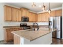 Modern kitchen featuring stainless steel appliances and an island at 29007 N 120Th Dr, Peoria, AZ 85383
