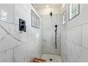 Walk-in shower with marble tile and rain shower head at 3914 E Carson Rd, Phoenix, AZ 85042