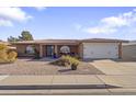 Front view of single-story home with desert landscaping and a two-car garage at 4047 E Catalina Cir, Mesa, AZ 85206