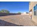 Large backyard with gravel and block wall at 4689 E Argentite St, San Tan Valley, AZ 85143