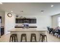 Modern kitchen with granite countertops and dark brown cabinets at 4689 E Argentite St, San Tan Valley, AZ 85143