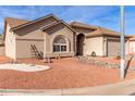 Tan colored stucco house with a large front yard and desert landscaping at 6940 S Sundown Dr, Chandler, AZ 85249