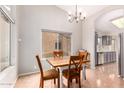 Charming dining area with a rustic table and chairs, adjacent to the kitchen at 19522 N 84Th Ave, Peoria, AZ 85382