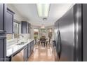 Modern kitchen with gray cabinets, a breakfast nook, and ample counter space at 19522 N 84Th Ave, Peoria, AZ 85382