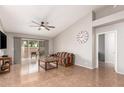 Spacious living room featuring a cozy sofa, large windows, and tile floors at 19522 N 84Th Ave, Peoria, AZ 85382