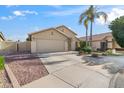 Single-story house with a two-car garage and desert landscaping at 20943 N 85Th Ln, Peoria, AZ 85382