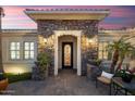 Inviting entryway featuring a charming stone facade and wrought iron door at 22926 N De La Guerra Ct, Sun City West, AZ 85375