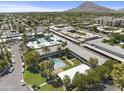 Aerial view of apartment community with pool, parking, and surrounding cityscape at 6834 E 4Th St # 7, Scottsdale, AZ 85251
