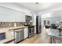 Modern kitchen with stainless steel appliances, concrete countertops, and glass-top dining table at 6834 E 4Th St # 7, Scottsdale, AZ 85251