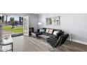 Living room with access to backyard, leather couch and chair, and a modern aesthetic at 6834 E 4Th St # 7, Scottsdale, AZ 85251