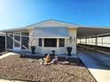 Inviting single-wide manufactured home with carport and landscaped front yard at 9302 E Broadway Rd # 184, Mesa, AZ 85208