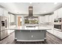 Spacious kitchen featuring a large island, stainless steel appliances, and white cabinetry at 12773 W Caraveo Pl, Peoria, AZ 85383