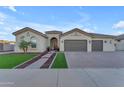 Beautiful single-story home with a three-car garage and landscaped front yard at 21559 E Russet Rd, Queen Creek, AZ 85142