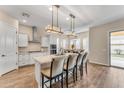 Modern kitchen with white cabinets, granite countertops, and an island at 21559 E Russet Rd, Queen Creek, AZ 85142