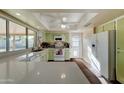 Bright kitchen with light green cabinets and modern appliances at 3345 E Desert Cove Ave, Phoenix, AZ 85028