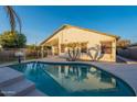 Inviting kidney-shaped pool with surrounding landscaping, backyard view at 4211 E Augusta Ave, Chandler, AZ 85249