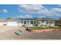 Single story home with solar panels and nicely landscaped front yard at 10754 W Brookside Dr, Sun City, AZ 85351