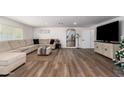 Bright and airy living room with sectional sofa and hardwood floors at 13050 N 17Th Ave, Phoenix, AZ 85029