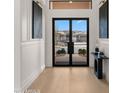 Bright and airy entryway with modern light fixtures and hardwood floors at 21057 N 74Th Way, Scottsdale, AZ 85255