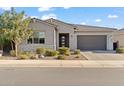 Single-story home with gray exterior, landscaped front yard, and two-car garage at 2835 E Los Gatos Dr, Phoenix, AZ 85050