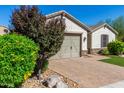 Front view of the house showcasing the garage and landscaping at 33907 N 29Th Dr, Phoenix, AZ 85085