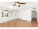 Bright living room with wood-look floors and ceiling fan at 2527 N 61St Ave, Phoenix, AZ 85035