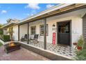 Inviting front porch with rocking chairs and patterned tile floor at 4015 E Catalina Dr, Phoenix, AZ 85018