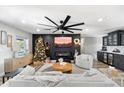 Open living room with a large TV, fireplace, and plenty of seating at 4015 E Catalina Dr, Phoenix, AZ 85018