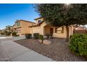 Two-story house with tan exterior, attached garage, and landscaped front yard at 45335 W Rhea Rd, Maricopa, AZ 85139