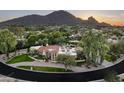Luxury estate nestled in a lush landscape with mountain backdrop at 6301 E Huntress Dr, Paradise Valley, AZ 85253