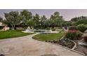 Landscaped backyard oasis with pool, patio, and putting green at 6301 E Huntress Dr, Paradise Valley, AZ 85253