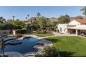 Inviting pool and spa surrounded by a beautifully landscaped backyard at 6301 E Huntress Dr, Paradise Valley, AZ 85253