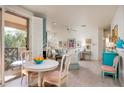 Charming dining area with white table and chairs, near sliding door to balcony at 9550 E Thunderbird Rd # 259, Scottsdale, AZ 85260