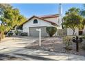 Front view of a charming home with a gray garage door at 10587 E Caron St, Scottsdale, AZ 85258