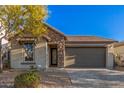 Single-story home with stone accents and a two-car garage at 28965 N 120Th Dr, Peoria, AZ 85383
