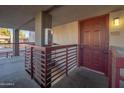 Condo entrance with a red door and metal railing at 3435 W Danbury Dr # B201, Phoenix, AZ 85053