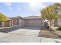 Front view of a one-story house with a two-car garage at 40925 W Patricia Ln, Maricopa, AZ 85138