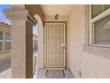 Front entry with arched entryway and security door at 40925 W Patricia Ln, Maricopa, AZ 85138