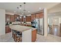 Eat-in kitchen with large island, stainless steel appliances, and hardwood floors at 4510 N Pierce Ct, Buckeye, AZ 85396