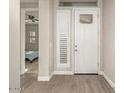 Bright entryway with interior door and built-in shelving at 5273 N 207Th Dr, Buckeye, AZ 85396