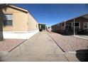 Driveway between two tan mobile homes at 9431 E Coralbell Ave # 124, Mesa, AZ 85208