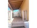 Covered porch with wooden deck and railing at 9431 E Coralbell Ave # 124, Mesa, AZ 85208
