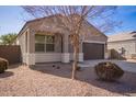 House exterior showcasing a front yard with gravel and a tree at 1241 E Paul Dr, Casa Grande, AZ 85122