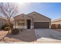 Tan house with a two-car garage and small front yard at 1241 E Paul Dr, Casa Grande, AZ 85122