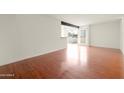Bright living room with hardwood floors and access to a patio at 3828 N 32Nd St # 104, Phoenix, AZ 85018