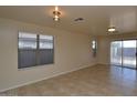 Living room with tile floors and sliding glass doors to backyard at 6709 W Luke Ave, Glendale, AZ 85303