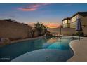 Relaxing kidney shaped pool with a spa and a waterfall feature at 2801 W Silver Fox Way, Phoenix, AZ 85045