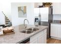 Modern kitchen island with granite countertops, stainless steel appliances, and double sink at 5720 S Daisy Patch Pl, Phoenix, AZ 85040